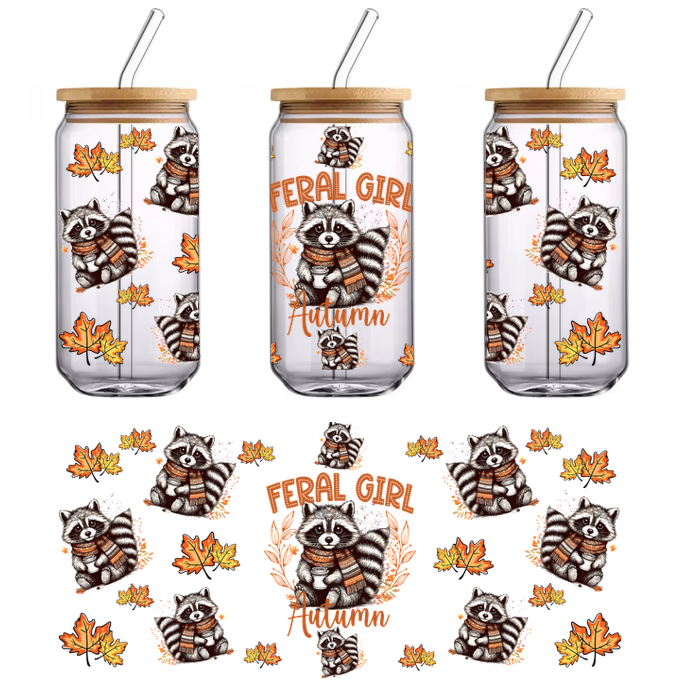 Un diseño caprichoso que presenta lindos mapaches con bufandas, rodeados de hojas de otoño y el texto "Feral Girl" en colores vibrantes. Transferencias UV.