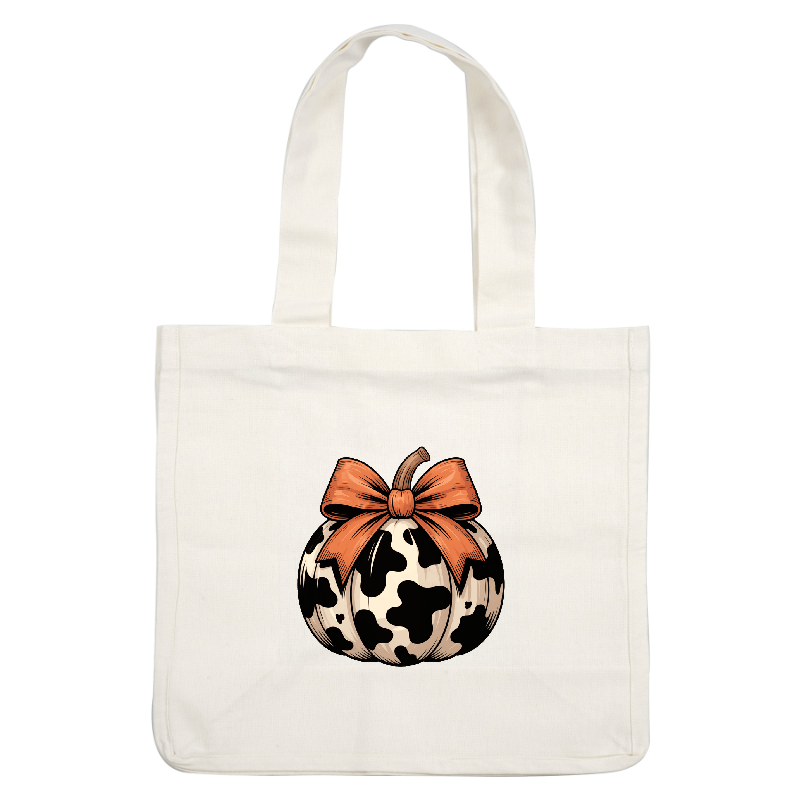 A whimsical black-and-white cow-patterned pumpkin adorned with a vibrant orange bow.DTF Transfers