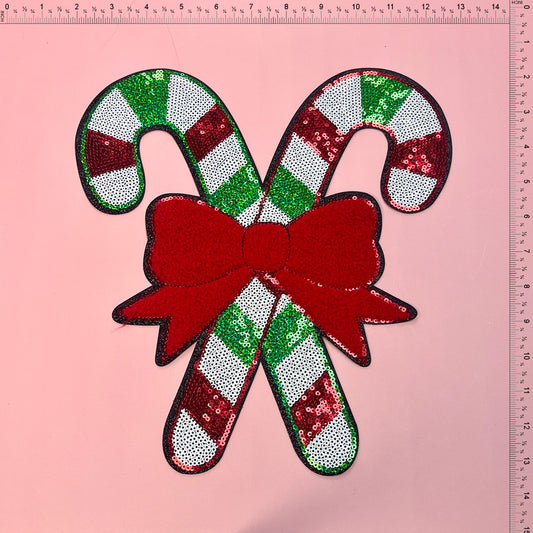 A festive, sequin-embellished candy cane decoration featuring vibrant red and green colors, perfect for holiday cheer.Patches