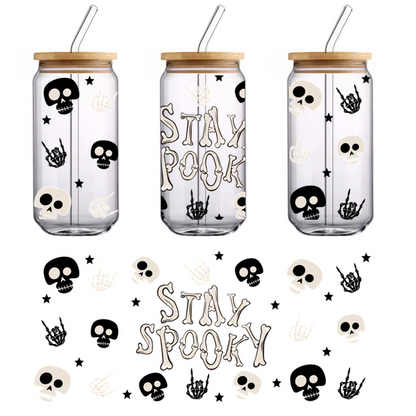 A fun and spooky design featuring the phrase "STAY SPOOKY" surrounded by playful skulls and spooky hand symbols.UV Transfers dtf prints