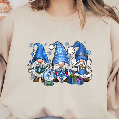 Three cheerful winter gnomes in blue hats, each with festive accessories like a snow globe, gifts, and a treat-filled bucket.DTF Transfers dtf transfers