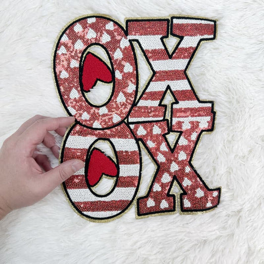 Bright and festive "XO" decor piece featuring sparkling sequins and playful heart patterns, perfect for Valentine's celebrations!Patches