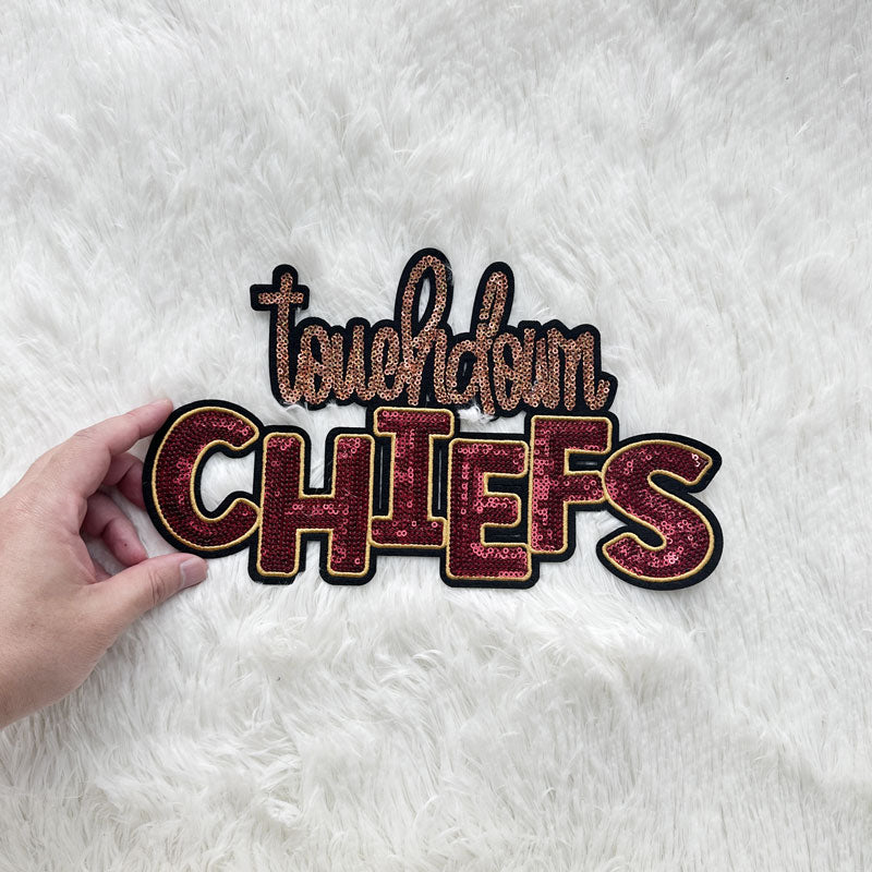 A sparkling "Touchdown Chiefs" sign featuring vibrant red and gold sequins, perfect for cheering on your favorite team!Patches