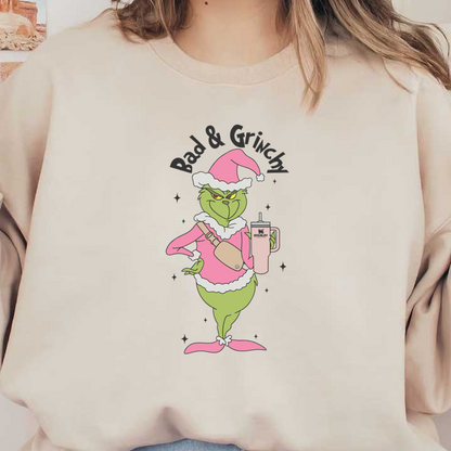 A playful illustration of the Grinch in a pink holiday outfit, holding a Stanley tumbler, exuding a grumpy yet festive vibe.DTF Transfersdtf regular iron