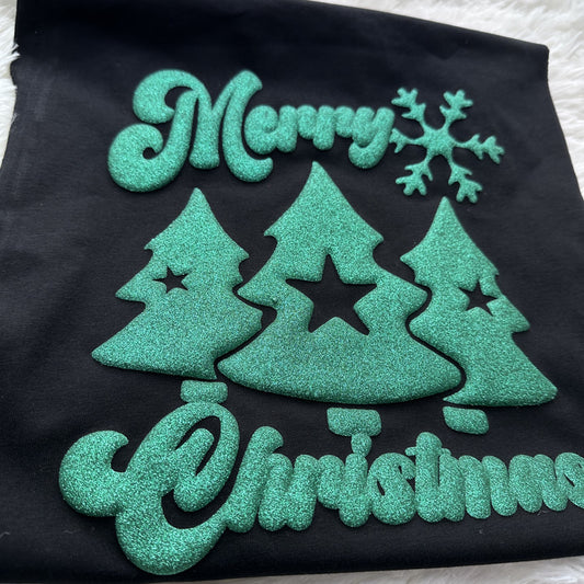 This festive design features shimmering green Christmas trees and "Merry Christmas" text against a classic black background.DTF Transfers puff