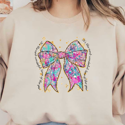 A vibrant and colorful bow adorned with a mix of pink and turquoise patterns, accented with sparkling gold glitter.DTF Transfers dtf transfers