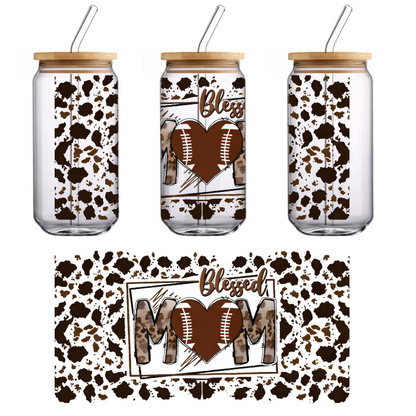 A stylish graphic design featuring "Blessed MOM" with a heart and football elements, set against a trendy leopard print background.UV Transfers dtf transfers