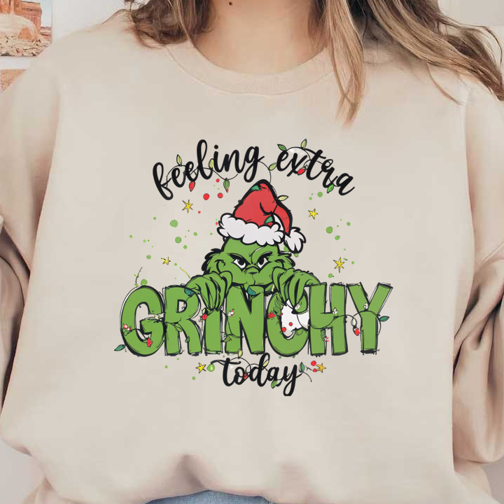 A playful holiday graphic featuring the Grinch in a Santa hat, accompanied by festive text that reads "Feeling Extra Grinchy Today."DTF Transfersdtf regular iron