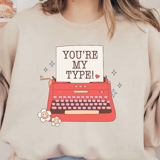 A charming vintage typewriter with a playful note reading "YOU’RE MY TYPE!" surrounded by flowers and sparkles.DTF Transfers