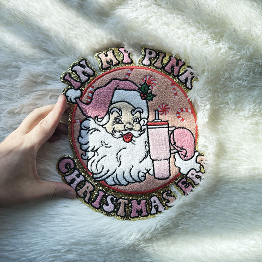 This playful patch features a charming Santa holding a pink drink, surrounded by festive candy canes, perfect for holiday decor.Patches