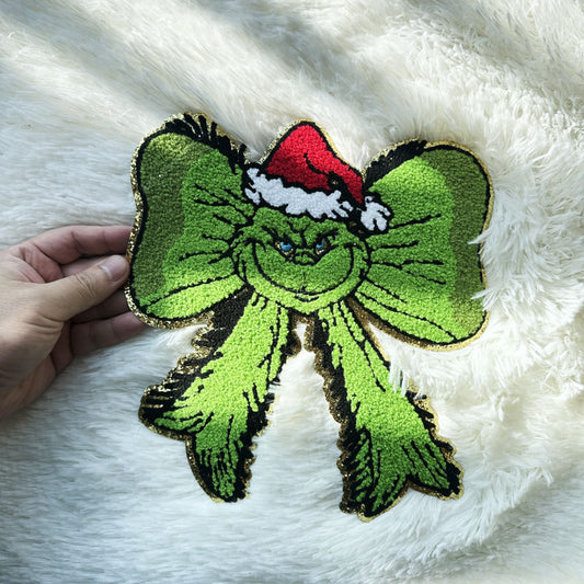 Festive and fun, this vibrant Grinch-themed bow features a jolly Santa hat, perfect for holiday decorations!Patches