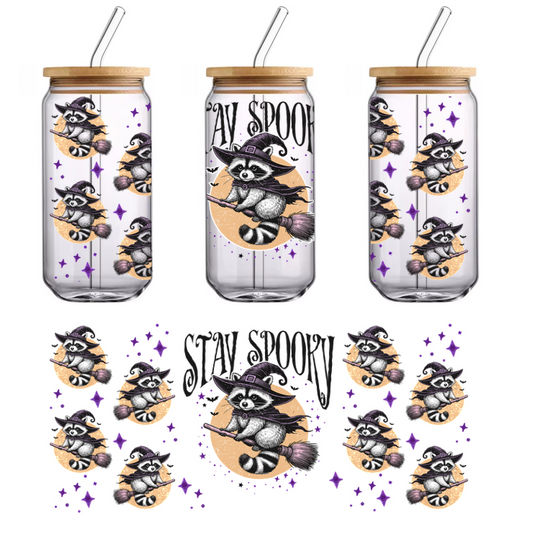 A whimsical illustration featuring a charming raccoon in a witch's hat flying on a broomstick, surrounded by sparkling stars.UV Transfersdtf regular iron