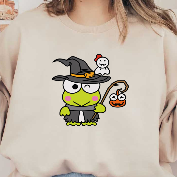 A whimsical green frog in a witch's hat and cloak holds a spooky lantern, accompanied by a friendly ghost.DTF Transfersdtf regular iron