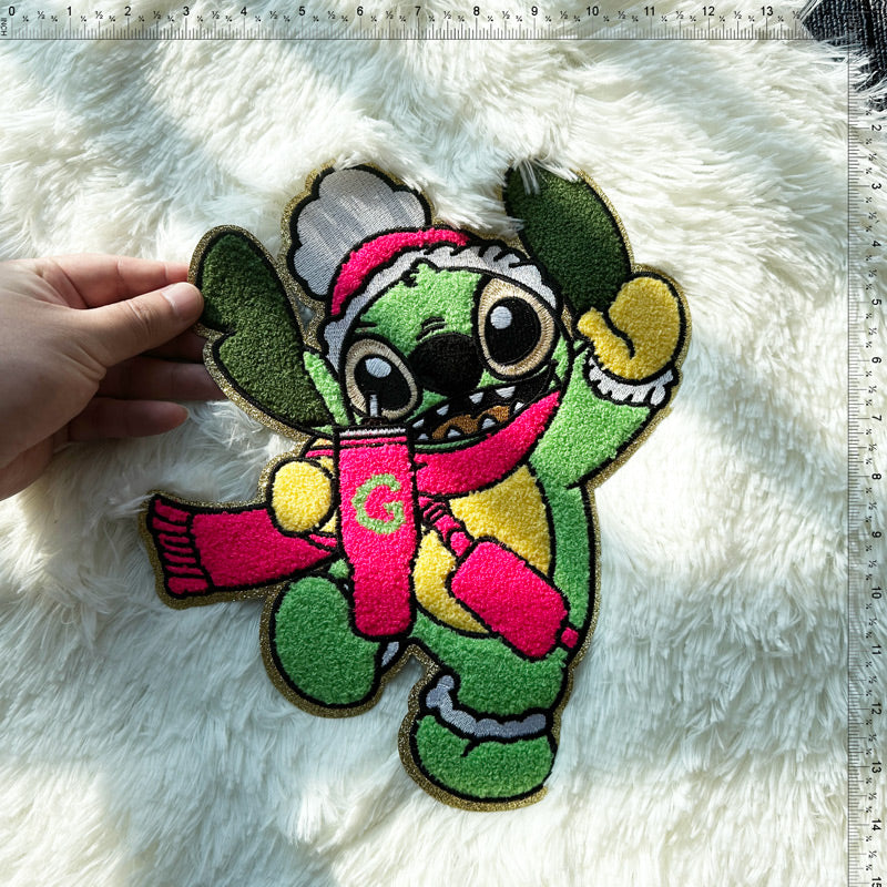 This colorful embroidered patch features a cheerful character in winter attire, vibrant with details like a scarf and festive hat.Patches