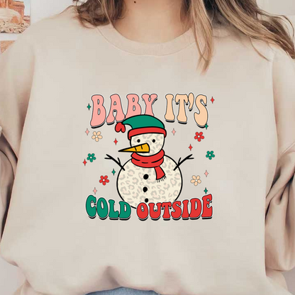 A whimsical snowman wearing a colorful hat and scarf with the playful phrase "Baby it's cold outside," surrounded by cheerful flowers. dtf prints