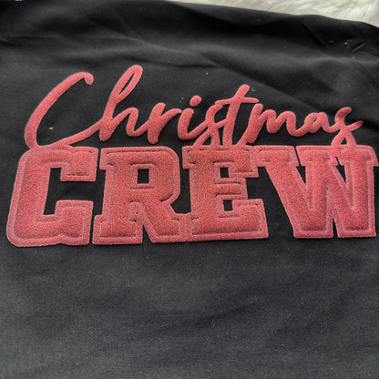 Celebrate the season in style with this cozy black sweatshirt featuring festive "Christmas Crew" lettering in bold red.DTF Transfers puff