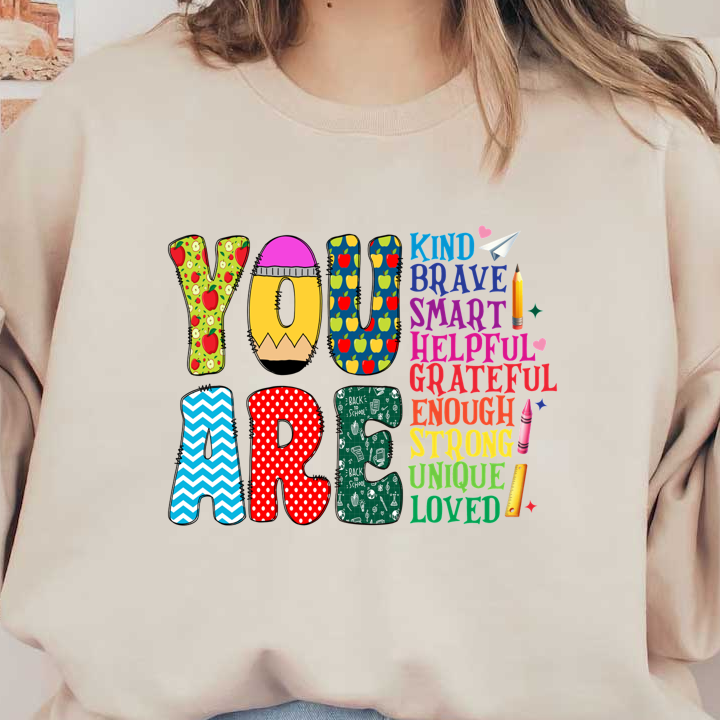 A colorful and cheerful design highlighting positive affirmations, spelling "YOU ARE" with vibrant letters and uplifting adjectives like "kind," "brave," and "unique."DTF Transfers