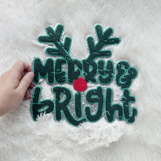 Celebrate the season with this vibrant "Merry & Bright" holiday sign featuring festive antlers and a cheerful red bauble!Patches