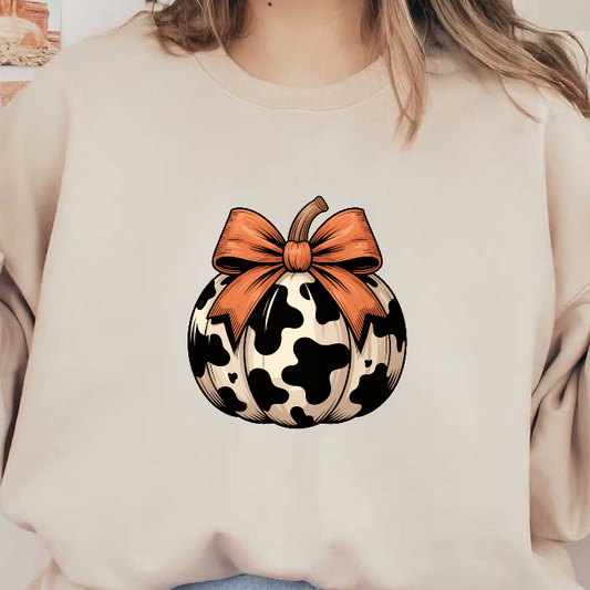 A whimsical black-and-white cow-patterned pumpkin adorned with a vibrant orange bow.DTF Transfers
