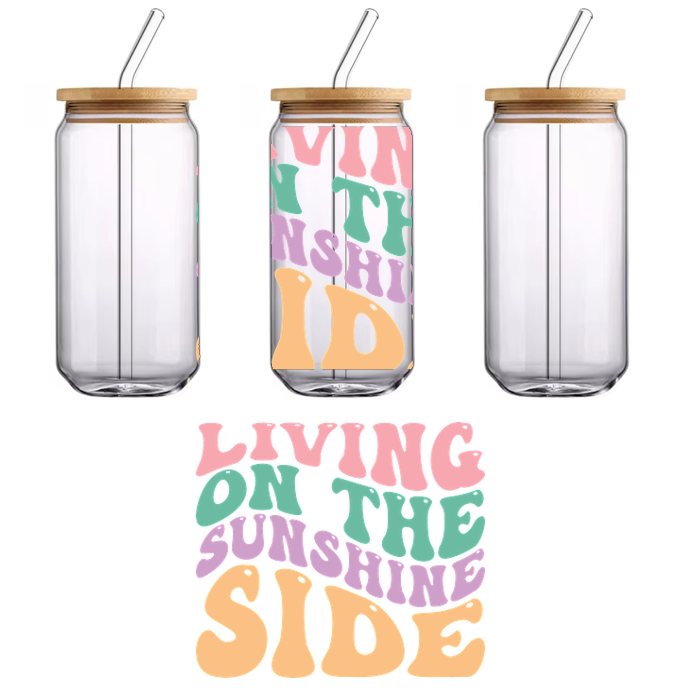 A vibrant, playful design featuring retro-style text that reads "Living on the Sunshine Side" in cheerful colors.UV Transfers dtf transfers