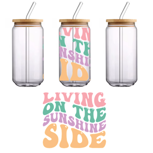 A vibrant, playful design featuring retro-style text that reads "Living on the Sunshine Side" in cheerful colors.UV Transfers dtf transfers