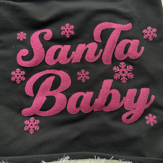 A festive black fabric featuring sparkling pink lettering that reads "Santa Baby," adorned with cheerful snowflake designs.DTF Transfers puff