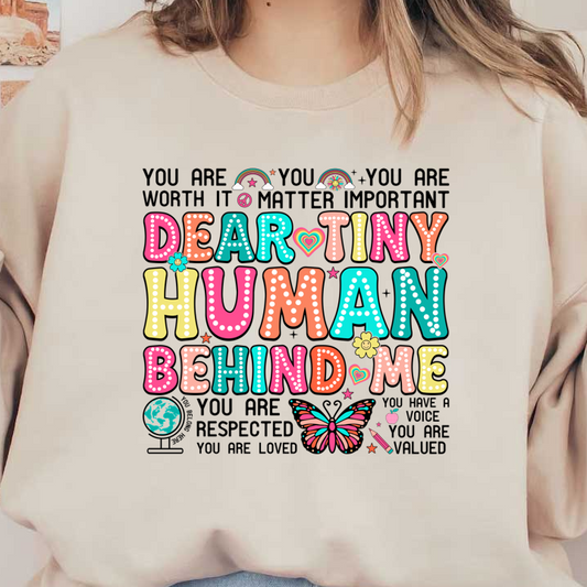A colorful and playful phrase reads, "Dear Tiny Human Behind Me," surrounded by whimsical designs like butterflies, flowers, and stars.DTF Transfers