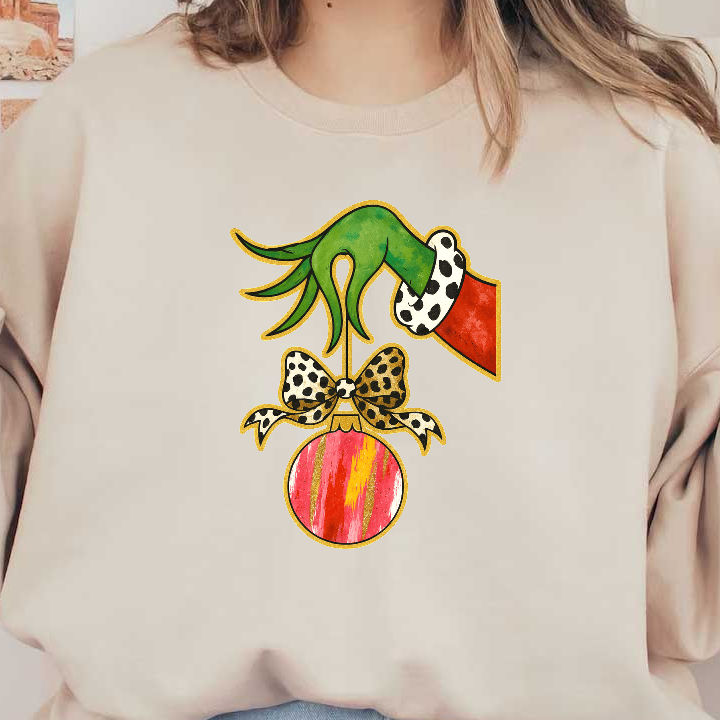 A whimsical green hand is hanging a colorful Christmas ornament with a bow.DTF Transfers