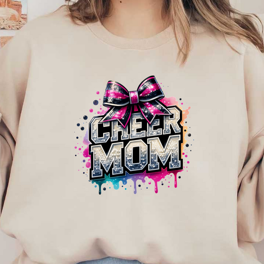 A vibrant graphic design featuring the words "CHEER MOM" adorned with a shiny bow and colorful splashes, celebrating cheerleading pride.DTF Transfers dtf transfers