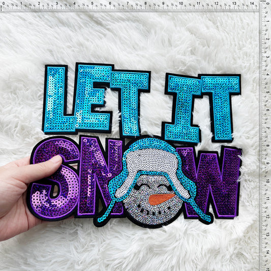 A vibrant and festive "Let It Snow" sign featuring sparkling letters and a cheerful snowman design, perfect for holiday decor.Patches