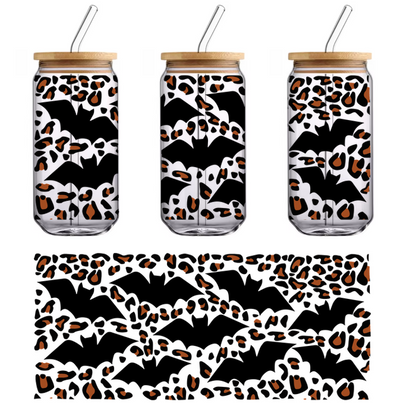 A playful pattern of abstract orange and black shapes resembling pebbles or drops, creating a vibrant, artistic design.UV Transfers dtf prints