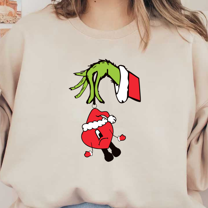 A whimsical illustration features a green Grinch-like hand playfully lifting a red ornament with a Santa hat, expressing frustration.DTF Transfers dtf transfersdtf regular iron