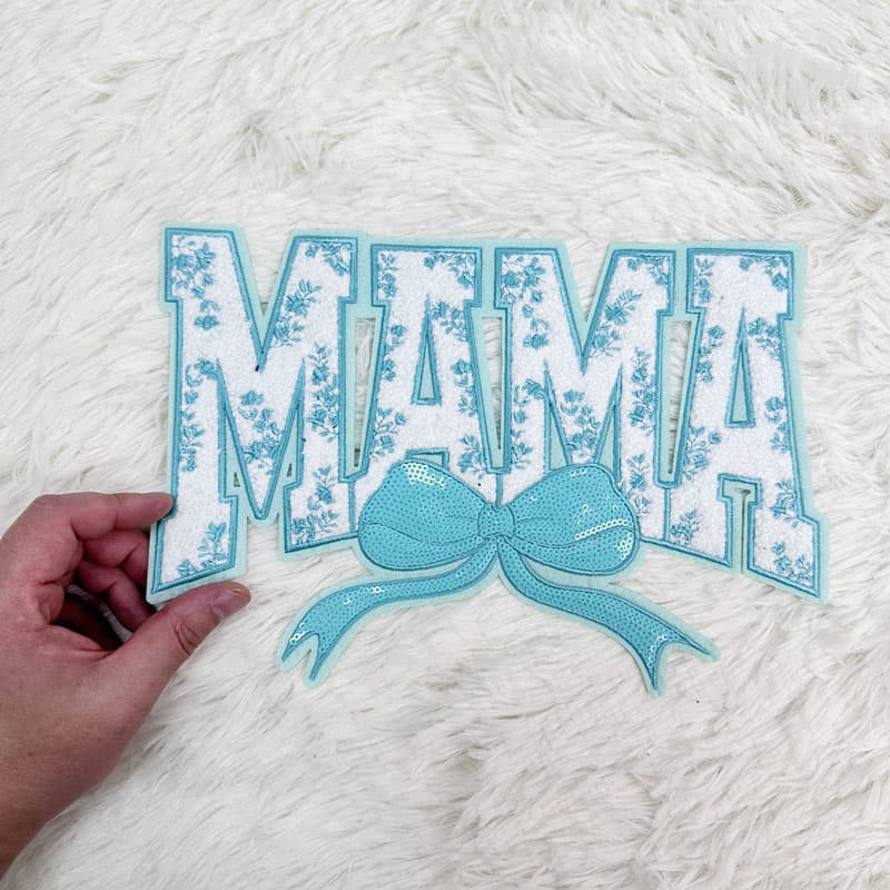 Colorful "MAMA" patches featuring sequined bows, available in pink, red, blue, and light blue, perfect for crafting or embellishing.Patches