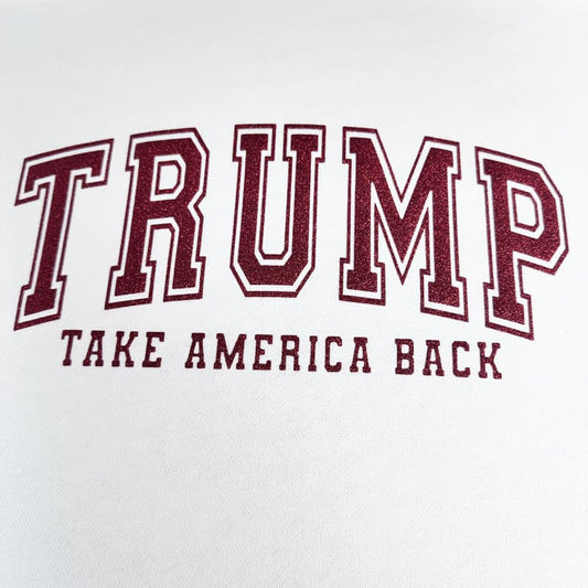 This black t-shirt features bold red lettering that reads "TRUMP" with "TAKE AMERICA BACK" beneath it, making a political statement.DTF Transfers puff