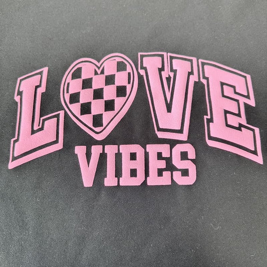 Bold ‘Love Vibes’ design with a pink checkerboard heart and varsity-style lettering, perfect for trendy apparel or gifts.DTF Transfers puff