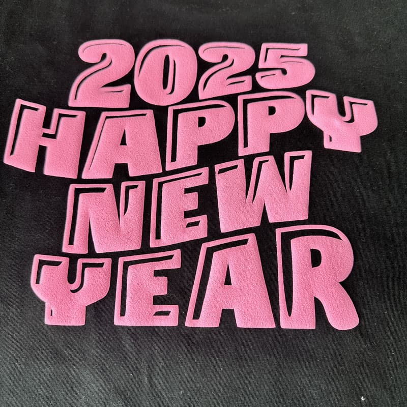 Bold and festive pink lettering saying ‘2025 HAPPY NEW YEAR,’ perfect for celebratory apparel or holiday decorations.DTF Transfers puff