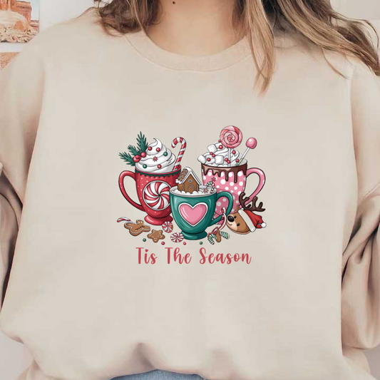 A festive illustration of three cozy mugs filled with winter treats, candies, and a charming gingerbread house, captioned "Tis The Season." heat press transfers