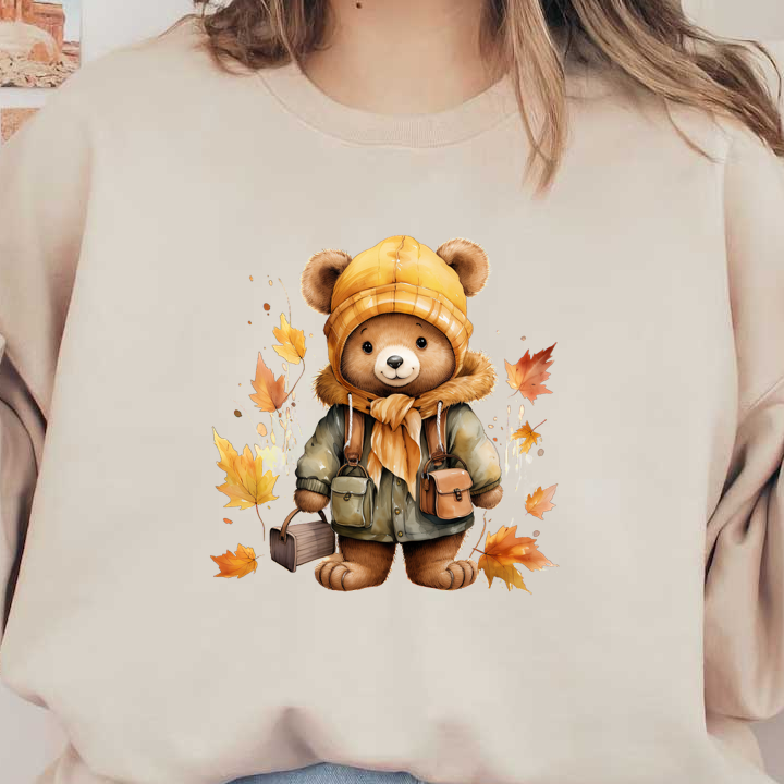 A cute teddy bear dressed in a yellow beanie and warm jacket, surrounded by autumn leaves, holding little bags.dtf regular iron