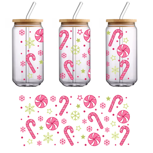 A festive pattern featuring pink and white peppermint swirls, candy canes, and charming yellow snowflakes and stars against a black background.UV Transfers heat press transfers