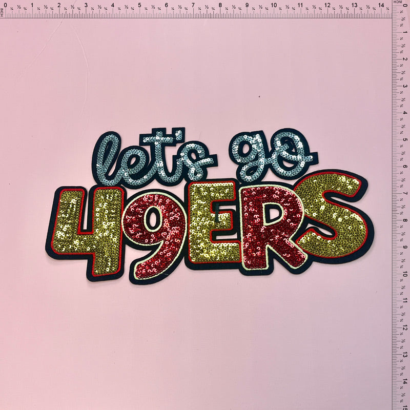 Sparkly "Let's Go 49ers" sign featuring shiny red, gold, and blue letters, perfect for showing team spirit!Patches