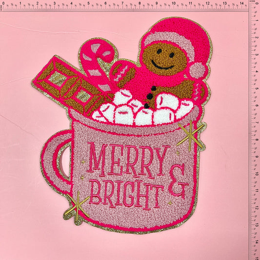 Celebrate the holiday season with this vibrant pink mug design featuring a gingerbread person, candy cane, marshmallows, and "Merry & Bright" text.Patches