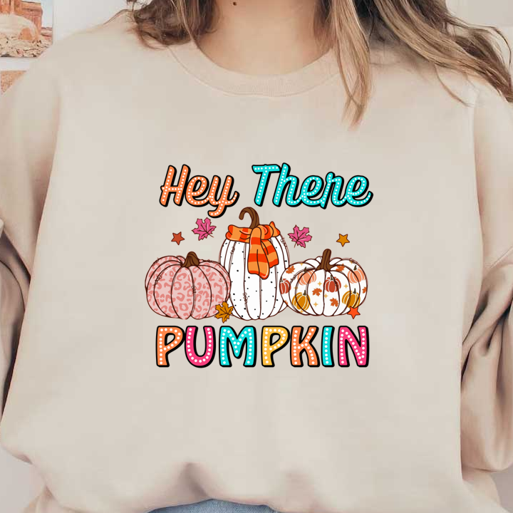 A playful autumn illustration featuring three decorative pumpkins with a colorful "Hey There Pumpkin" text and vibrant fall leaves. dtf transfers