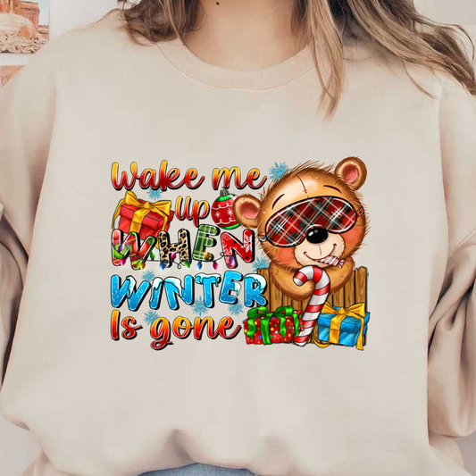 A cheerful, cartoonish bear in pajamas holding a candy cane, surrounded by colorful gifts, with the playful text, "Wake me up when winter is gone."DTF Transfers heat press transfers