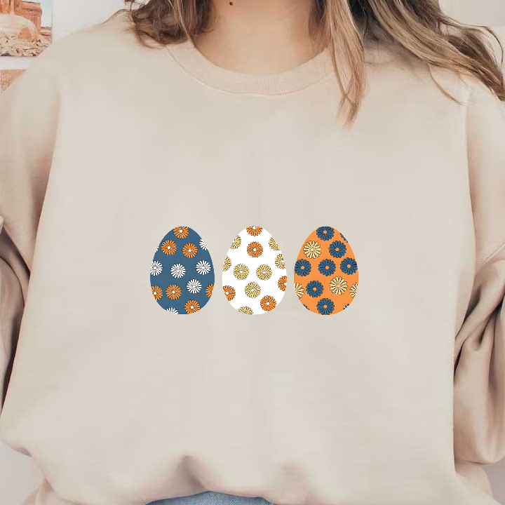 A charming trio of patterned Easter eggs featuring floral designs in vibrant blue, orange, and white colors.DTF Transfers