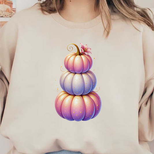 Un trío caprichoso y apilado de calabazas de colores pastel adornadas con brillos y una delicada flor en la parte superior.