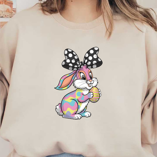 This colorful cartoon bunny, adorned with a polka-dot bow, happily holds a decorated Easter egg.DTF Transfers