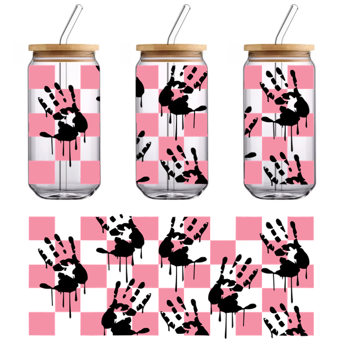 A playful design featuring black handprints with dripping details against a pink checkerboard background.UV Transfers heat press transfers