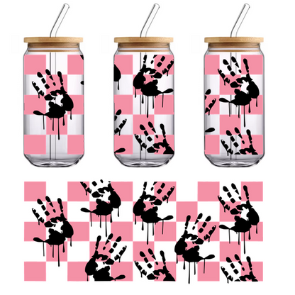 A playful design featuring black handprints with dripping details against a pink checkerboard background.UV Transfers heat press transfers