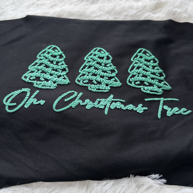 This festive black fabric features whimsical green embroidered Christmas trees and the playful phrase "Oh Christmas Tree."DTF Transfers puff