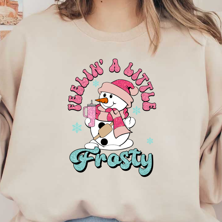 A cheerful snowman in a pink scarf and hat, holding a drink, with sparkling text that reads "Feelin' A Little Frosty." dtf transfers